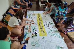 A creative break where participants painted on the canvas mural
